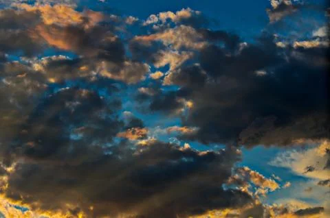 Dramatic sunset sky with colorful clouds after thunderstorm Stock Photos