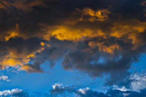 Dramatic sunset sky with colorful clouds after thunderstorm Stock Photos