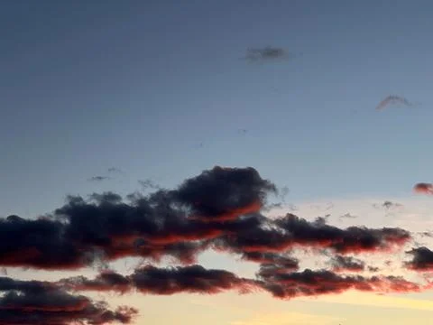 Dramatic Sunset Sky with Dark Clouds and Red Glow Stock Photos