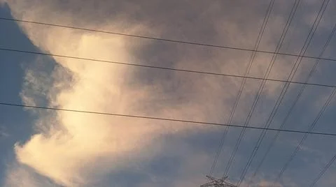Dramatic sunset sky with dramatic clouds and electric tower Stock Photos