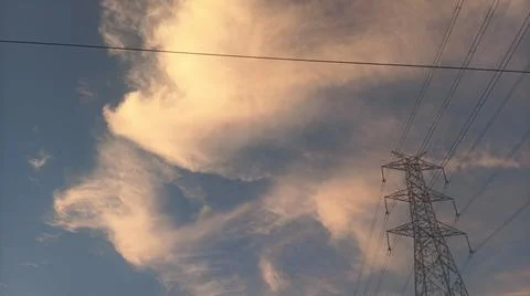 Dramatic sunset sky with dramatic clouds and electric tower Stock Photos