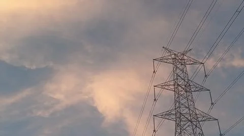 Dramatic sunset sky with dramatic clouds and electric tower Stock Photos