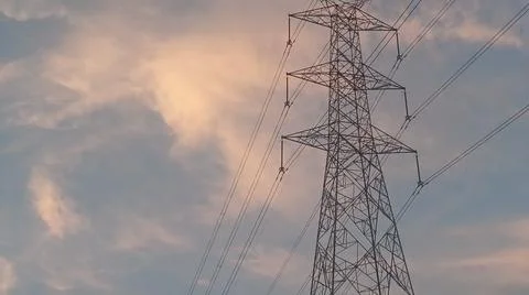 Dramatic sunset sky with dramatic clouds and electric tower Stock Photos