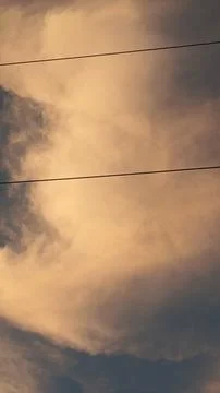 Dramatic sunset sky with dramatic clouds and electric tower Stock Photos