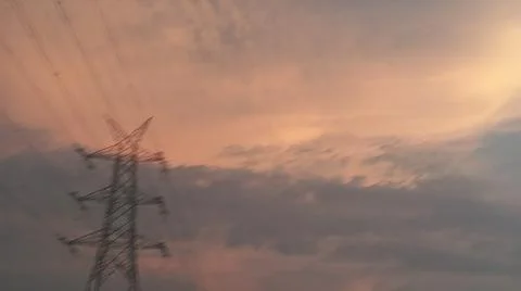 Dramatic sunset sky with dramatic clouds and electric tower Stock Photos