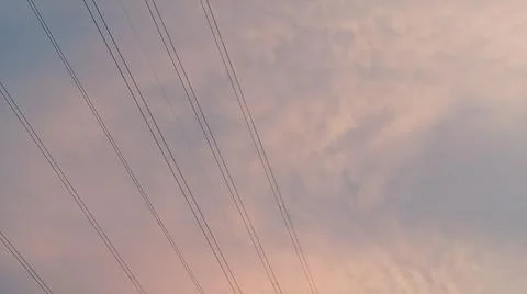 Dramatic sunset sky with dramatic clouds and electric tower Stock Photos