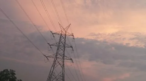 Dramatic sunset sky with dramatic clouds and electric tower Stock Photos