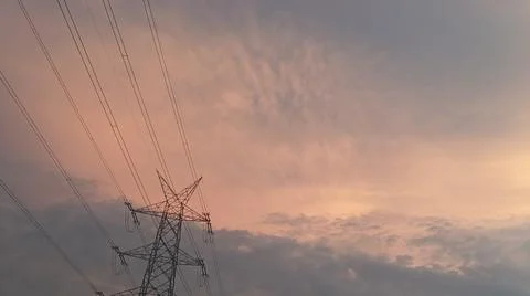 Dramatic sunset sky with dramatic clouds and electric tower Stock Photos