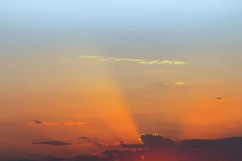 Dramatic sunset sky. Fiery bright colors of sun going down. Sunlight rays shi 写真素材