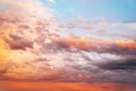 Dramatic sunset sky filled with colorful clouds illuminated by warm evening.. Stock Photos