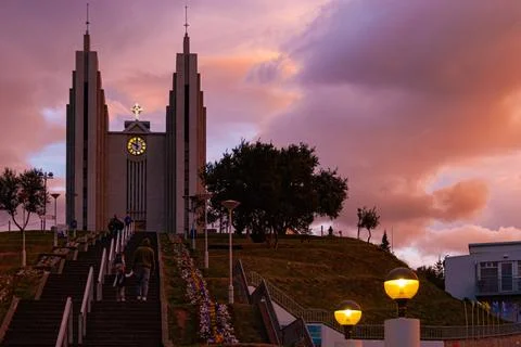 Dramatic sunset sky glowing above a large town church Stock Photos
