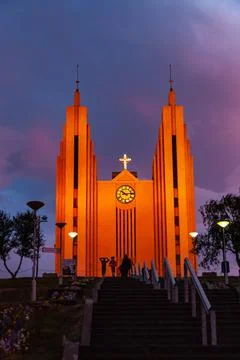 Dramatic sunset sky glowing above a large town church Stock Photos