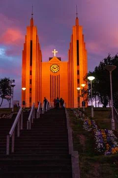 Dramatic sunset sky glowing above a large town church Stock Photos