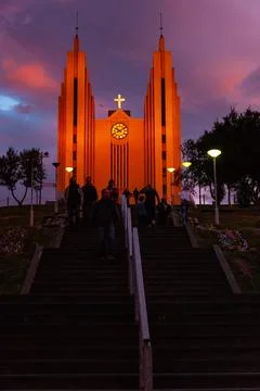 Dramatic sunset sky glowing above a large town church Stock Photos