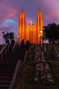 Dramatic sunset sky glowing above a large town church Stock Photos