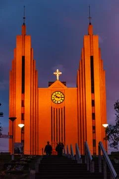 Dramatic sunset sky glowing above a large town church Stock Photos