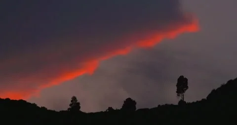 Dramatic sunset sky glowing over distant silhouetted hills Stock Footage 295628573
