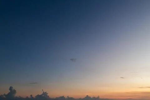 Dramatic sunset sky with gradient colors and cloud silhouettes for atmospheri Stock Photos