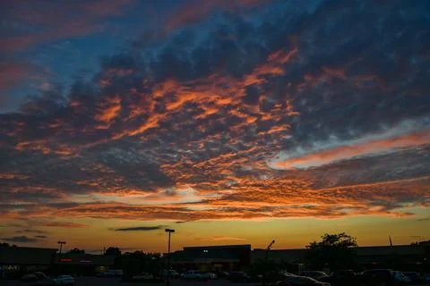 A dramatic sunset sky with gray, orange, pink, and blue clouds,  New Jersey.. Stock Photos