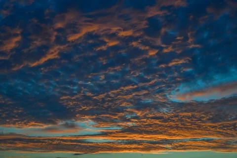 A dramatic sunset sky with gray, orange, pink, and blue clouds,  New Jersey.. Foto stock