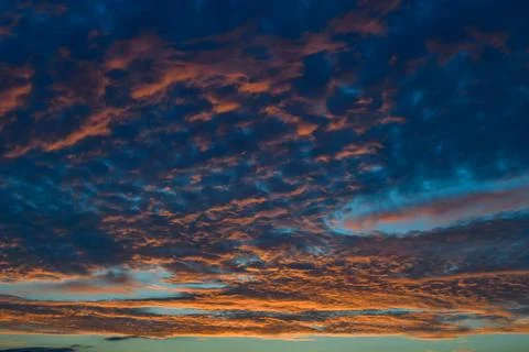 A dramatic sunset sky with gray, orange, pink, and blue clouds,  New Jersey.. Foto stock