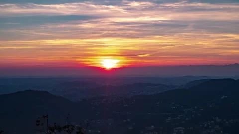 Dramatic sunset sky of magenta and red in thin clouds over mountains fades Stock Footage 143820581