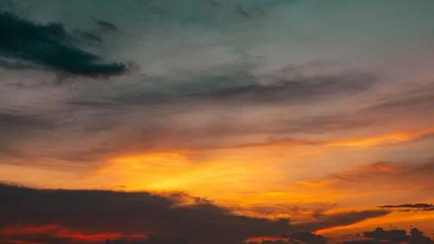 Dramatic Sunset Sky with Orange and Teal Clouds 스톡 사진