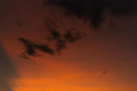 Dramatic Sunset Sky with Orange and Dark Clouds Stock Photos