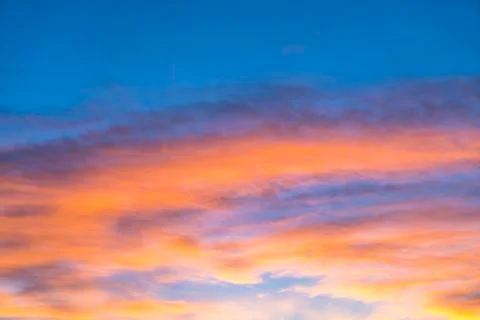Dramatic sunset sky with orange colored clouds in summer season.. Stock Photos