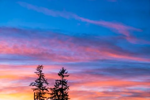 Dramatic sunset sky with orange colored clouds in summer season.. Stock Photos