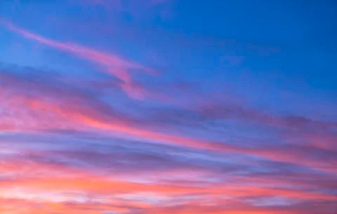 Dramatic sunset sky with orange colored clouds in summer season.. Stock Photos