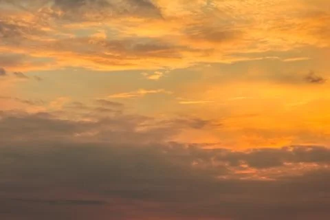 Dramatic sunset sky with orange colored clouds, colorful background Stock Photos