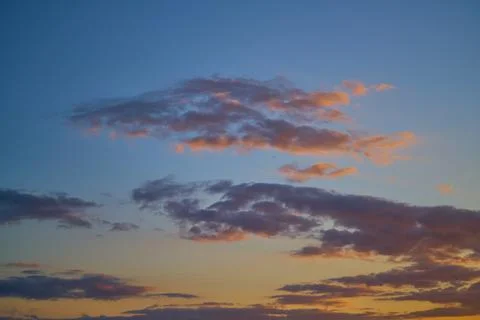 Dramatic sunset sky with orange colored clouds. Photos