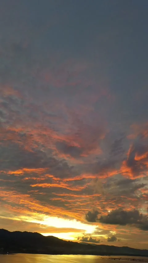 Dramatic Sunset Sky Over Calm Water Video stock 325483189