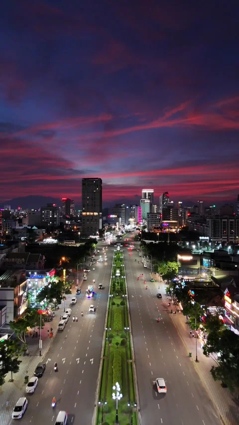 Dramatic Sunset Sky Over City Avenue with Night Traffic in Da Nang, Vietnam Stock Footage 335846658