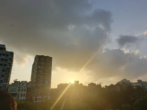 Dramatic sunset sky over city buildings and trees Stock Photos
