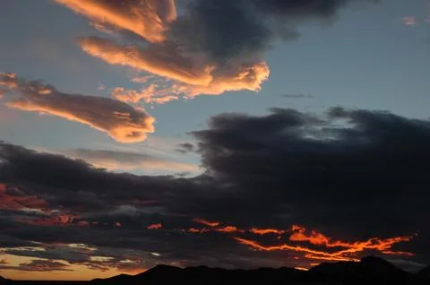 Dramatic sunset sky over mountain silhouette Stock Photos