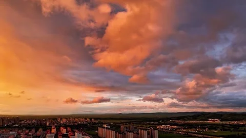 Dramatic Sunset Sky Over Urban Landscape and Rolling Hills Xilinhot Xilin Gol Stock Footage 346586630