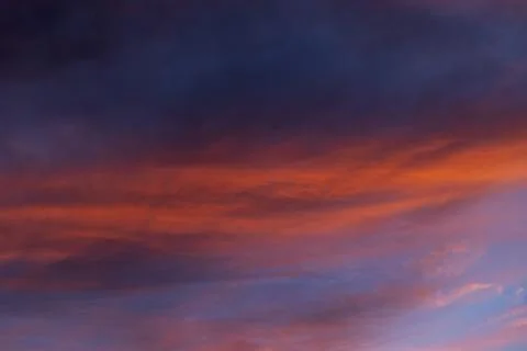 A dramatic sunset sky painted in deep reds, purples and blues Stock Photos