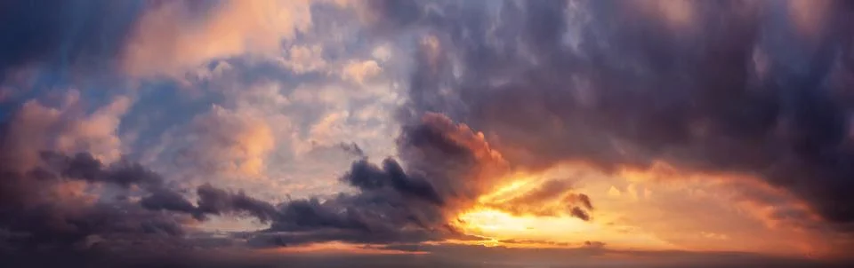 Dramatic sunset sky panorama during golden hour. Stock Photos
