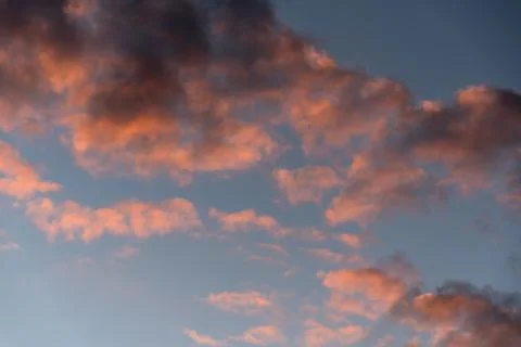 Dramatic sunset sky with pink clouds after the storm. Colorful cloud closeup Stock Photos