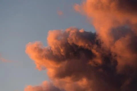 Dramatic sunset sky with pink clouds after the storm. Colorful cloud closeup Stock Photos
