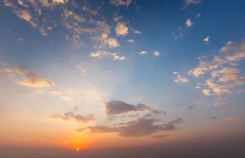Dramatic sunset sky showcasing vibrant colors and soft clouds Stock Photos