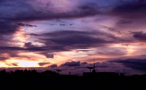 Dramatic Sunset Sky with Silhouetted Buildings Stock Photos