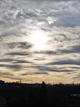 Dramatic Sunset Sky with Silhouetted Trees and Crane Stock-Fotos