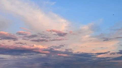 Dramatic Sunset Sky with Soft Pink and Blue Clouds Stock Photos