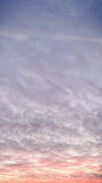 Dramatic sunset sky with textured clouds glowing in pink and orange colors .. Stock Photos