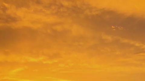 Dramatic sunset sky timelapse close up telephoto view featuring fiery orange Stock Footage 345172375