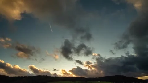 Dramatic Sunset Sky Timelapse With Dark Moving Clouds And Golden Light Stock Footage 323106749