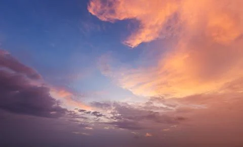 Dramatic sunset sky with vibrant colors and fluffy clouds at dusk Stock Photos